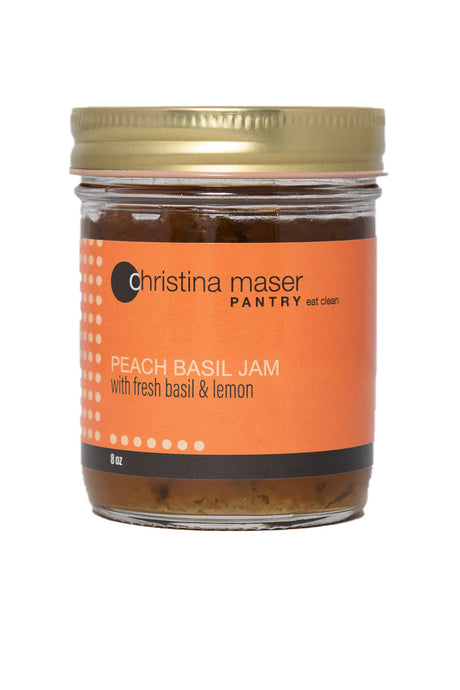Peach Basil Jam in clear glass mason jar with orange wraparound label. Jam is made with local Lancaster County peaches and organic cane sugar.