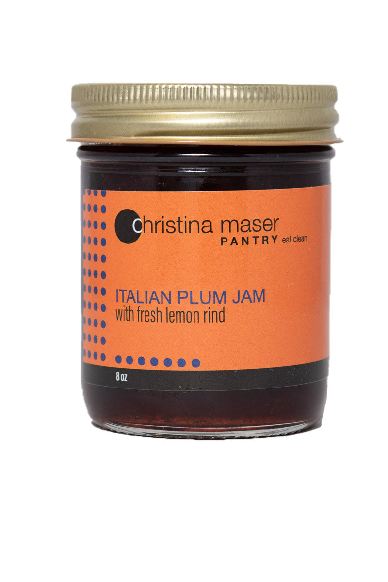 Italian Plum Jam in a clear glass mason jar with orange wraparound label with indigo colored accents. Made with local plums and organic cane sugar in small batches.