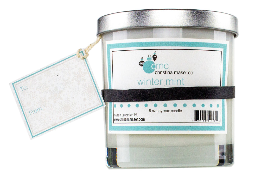Winter mint holiday special edition soy wax candle. 8 oz clear glass tumbler with silver metal lid. includes blank gift tag. great for holiday shopping and holiday gifting.