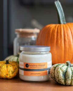 Christina Maser Co. Pure Pumpkin Candle Surrounded by Pumpkins and Gourds