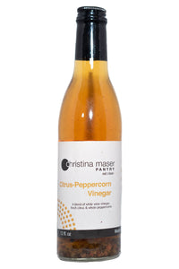 Citrus Peppercorn Vinegar in a wine bottle. Label is off-white with orange accents. Great as a marinade.