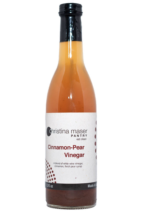 Cinnamon-Pear Vinegar in a tall, thin-necked bottle. Label is off-white with maroon accents.