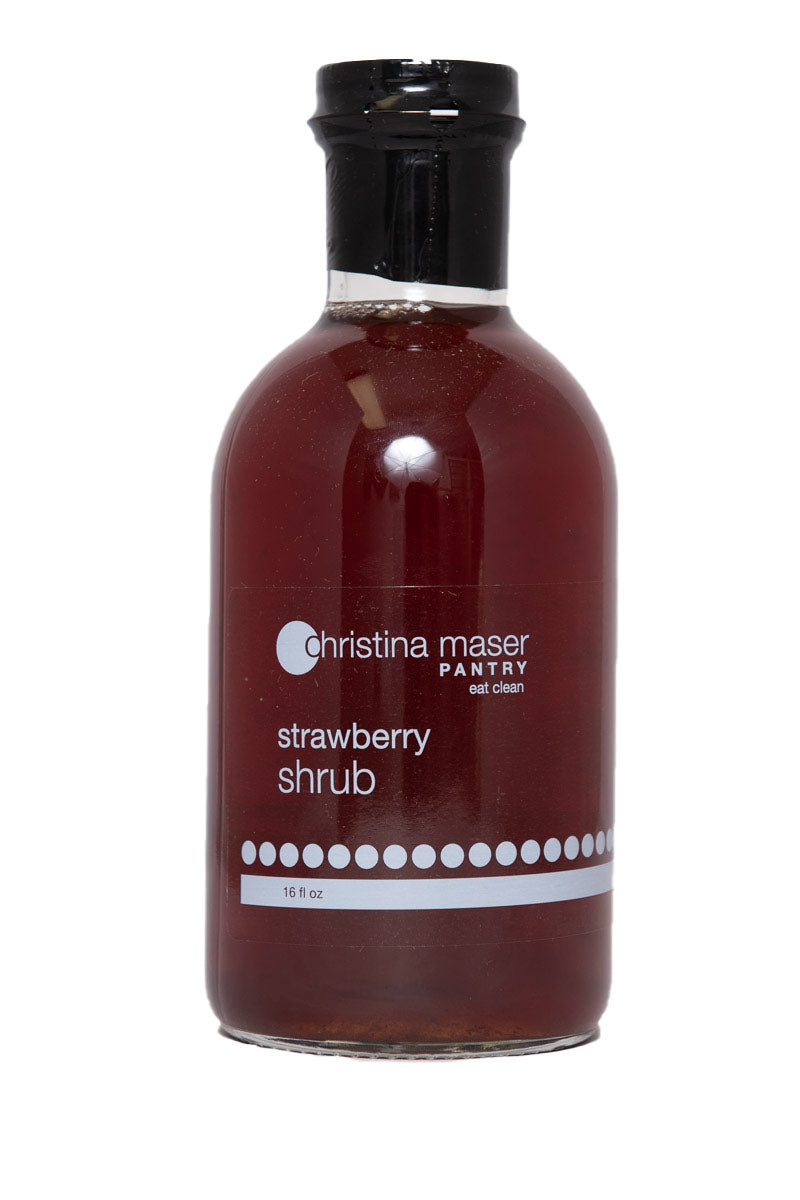 Strawberry Shrub or drinking vinegar in a wide glass bottle with a clear and white label. Made with organic sugar, apple cider vinegar, and local strawberries.