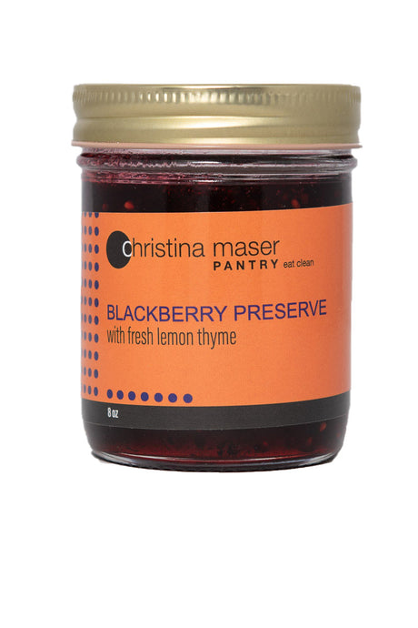 Blackberry Preserve with Lemon Thyme Jam in a glass mason jar with orange wraparound label. Made with fresh local ingredients.