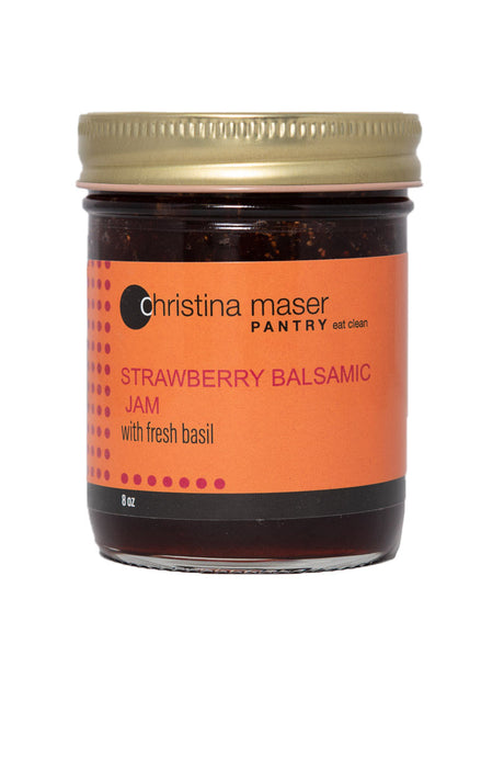 Strawberry Balsamic Jam in clear glass jar with orange label. Label has pinkish-red accents.