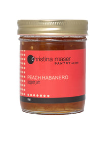 Peach Habanero pepper jam in clear glass mason jar with red wraparound label.