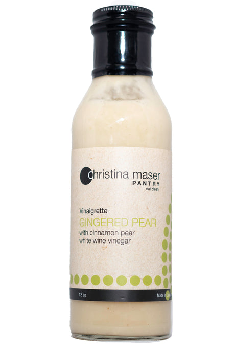 Gingered Pear vinaigrette in glass bottle. Label is off-white with pear green colored accents. Vinaigrette is creamy white.