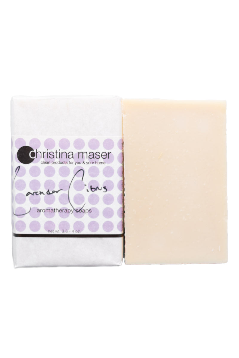 Lavender citrus vegan bar soap. Soap is natural colored and wrapped in white paper. Label has light purple dot accents and black text.