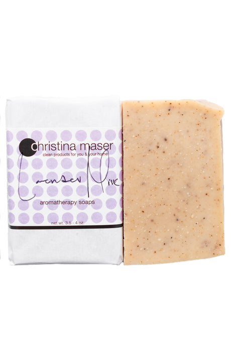 Lavender Milk bar soap. Soap is warm natural colored. Wrapped in white paper with label with purple dot accents.